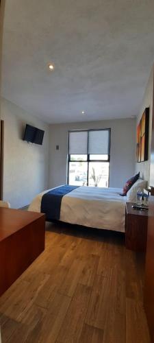 Ένα ή περισσότερα κρεβάτια σε δωμάτιο στο Hotel Del Valle