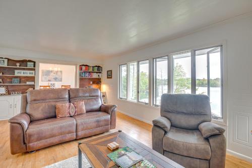 a living room with a couch and two chairs at Lakefront Home with Fire Pit in Eagle River in Eagle River