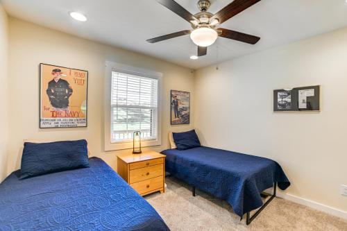 a bedroom with two beds and a ceiling fan at Kentucky Lake Home with Shared Dock! in Gilbertsville