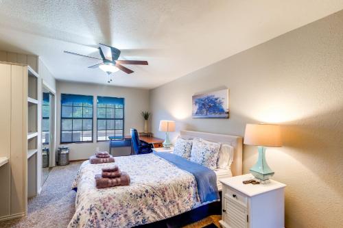 a bedroom with a bed and a ceiling fan at Lakefront Unit with Dock in Carlsbad! in Carlsbad