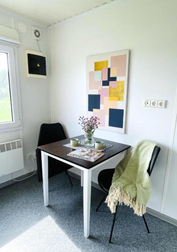 a dining room with a table and two chairs at Small studio close to Stegra - H2GS in Boden