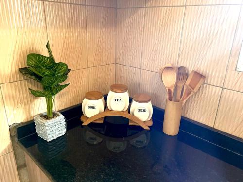 a counter top with a table with a kitchen utensils at Prime Two Bedroom Apartment, Kampala in Kampala