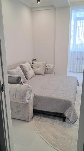 a bed and a couch in a room at Air-Moldova N1 in Chişinău