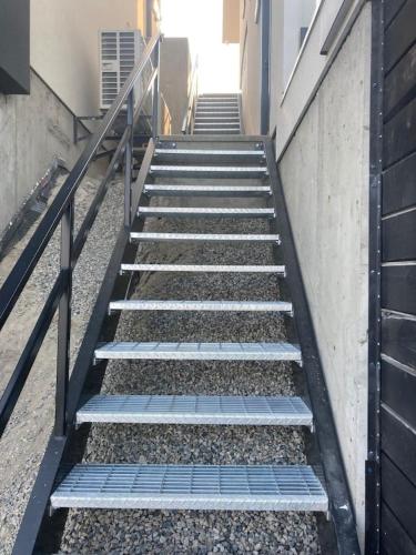 a set of stairs leading up to a building at Lakefront Nest Beach House Suite in Penticton