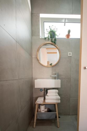 a bathroom with a sink and a mirror at Casa do Rio in Nazaré