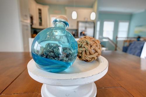 a glass jar with rocks in it next to a ball of rope at Ocean View - Just Steps from Oceanfront - 2 Full Width Sun Decks - 3 King Suites in North Topsail Beach