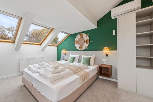 a bedroom with a large bed and green walls at VIVE Boutique Hotel Vienna in Vienna