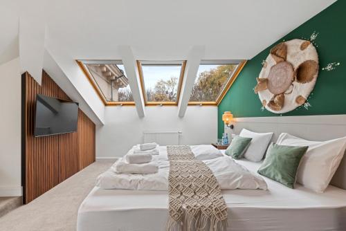 a bedroom with a large white bed with green walls at VIVE Boutique Hotel Vienna in Vienna