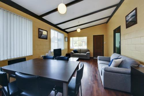 a living room with a table and a couch at Bella Beach 575-77 Straight St Hat Head in Hat Head