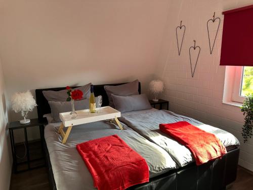 a bedroom with a bed with a table on it at Komfortables Ferienhaus 80qm unweit vom See in Lichtenberg - Frankenwald - Bad Steben - Hof Saale in Lichtenberg