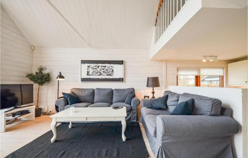 a living room with a couch and a table at Three-Bedroom Holiday Home In Ebeltoft in Ebeltoft