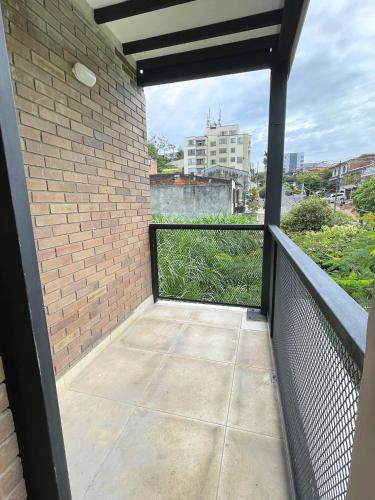 a balcony with a fence and a brick wall at M1145 Aparta Loft in Pereira