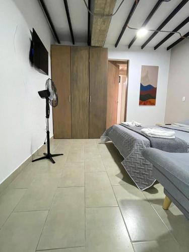 a room with a bed and a camera in it at M1145 Aparta Loft in Pereira