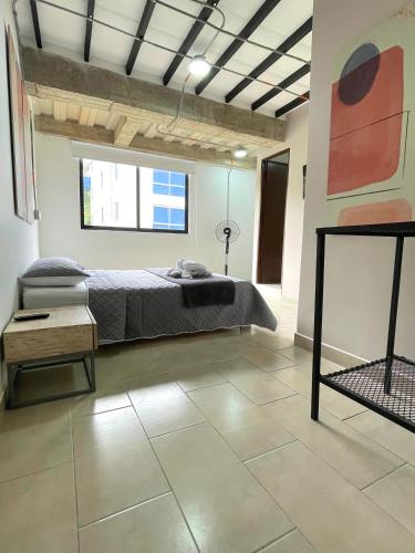 a bedroom with a bed in a room at M1145 Aparta Loft in Pereira