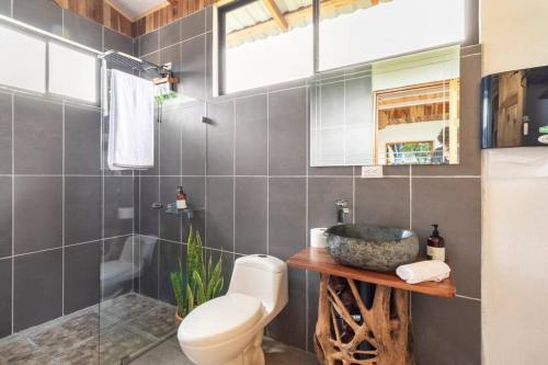 a bathroom with a toilet and a sink and a shower at Alas Romantic Chalet Monteverde in Monteverde Costa Rica