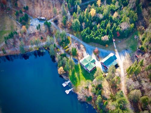 an aerial view of a house next to a lake at Domaine Gagnon in Saint Sebastien