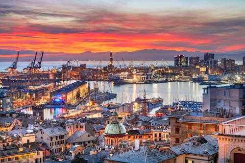 a view of a city with a harbor at sunset at Mare e Monti in Genova