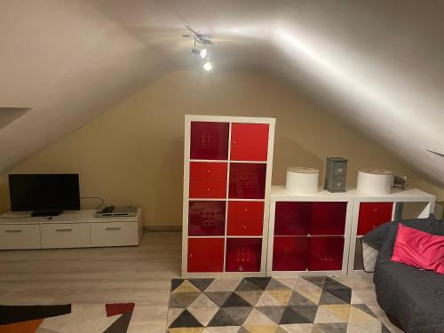 a living room with a white and red book shelf at Spacious apartment in Charleroi 100 m² with parking 5 ppl in Charleroi