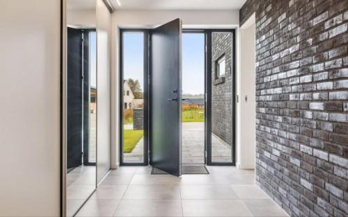 an open door with a brick wall at Bright, Quiet, Comfortable Room In A Luxury Home in Horsens
