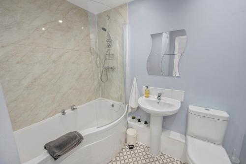 a bathroom with a sink and a shower and a toilet at Stunning 2BR Loft Apt in Oban - Sea Views in Oban