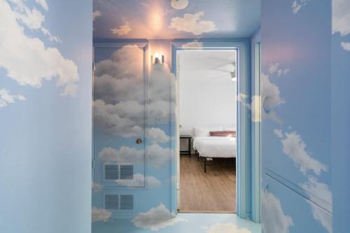 a room with a door with clouds painted on the wall at The Tempe Tango POOL and SPA Cute House in Tempe