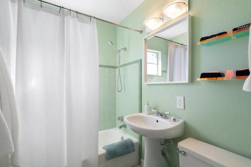 a bathroom with a white sink and a shower at The Tempe Tango POOL and SPA Cute House in Tempe