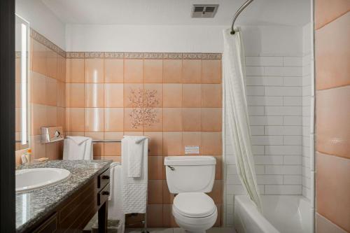 a bathroom with a toilet and a sink and a shower at Chateau Big Bear Boutique Hotel, BW Signature Collection in Big Bear Lake