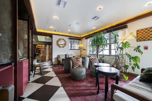 a lobby with a waiting area with couches and tables at Jefferson Hotel in Miami