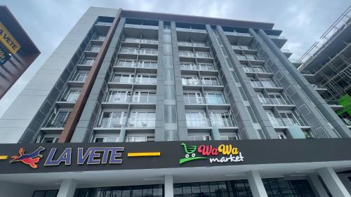 a large building with a sign in front of it at Luxury apartment 10 min to Airport Be Cariari Condo #402 in La Asunción