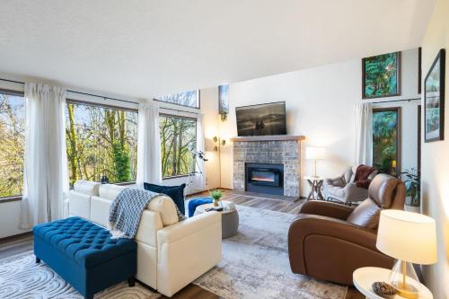a living room with couches and a fireplace at Uplake Forest Retreat in Kenmore