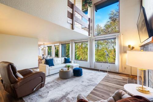 a large living room with a large window at Uplake Forest Retreat in Kenmore