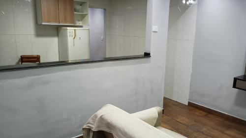 a bathroom with a mirror and a towel hanging on the wall at CASA NA PRAIA ITANHAEM para 10 pessoas com total conforto in Itanhaém