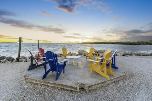 a group of chairs and tables on the beach at Keys Relaxing Getaway-Kawama K5 in Key Largo