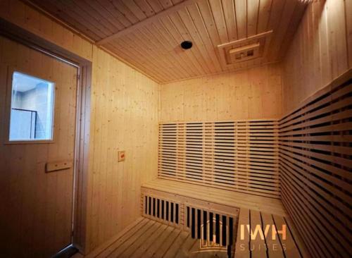 a sauna with a window in a wooden room at Sunway Onsen Signature Themepark Suites with Hotspring by IWH Suites in Ipoh