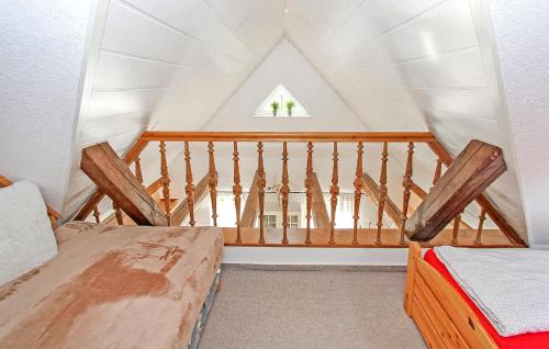 a attic room with two beds and a window at Ferienwohnung Südmüritz in Vipperow