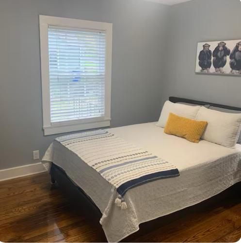 a bed with two pillows and a window in a bedroom at House, Near Downtown with Fenced Back Yard!!!! in Knoxville