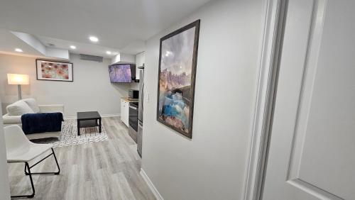 a living room with a painting on the wall at Garden Ave Home 1mins to HWY 403 in Brantford