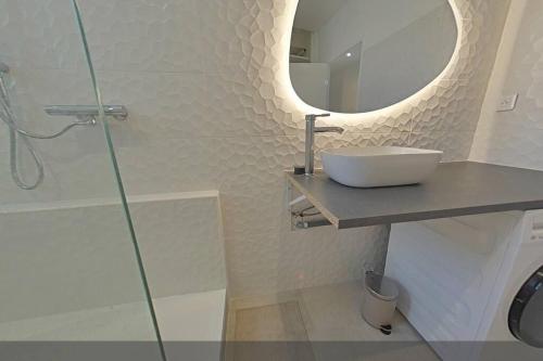 a bathroom with a sink and a mirror and a shower at 3 bedrooms-Very bright and spacious appt- wifi in Toulon