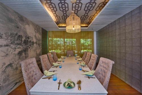 a dining room with a long table and chairs at Crowne Plaza Kochi by IHG in Cochin
