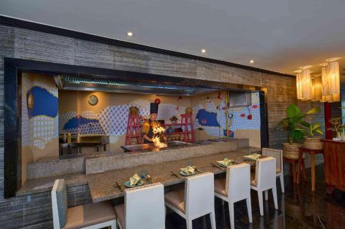a restaurant with a table and chairs and a fireplace at Crowne Plaza Kochi by IHG in Cochin
