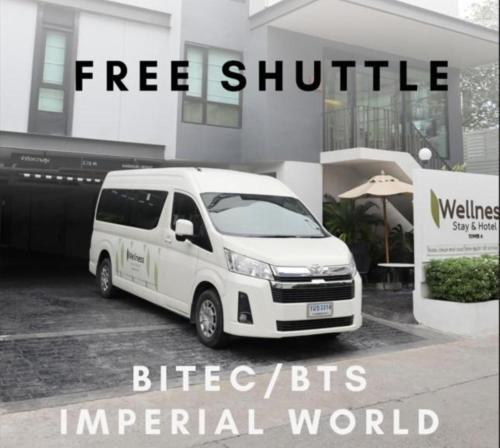 a white van parked in front of a building at Wellness Stay & Hotel Sukhumvit 107 in Bangna