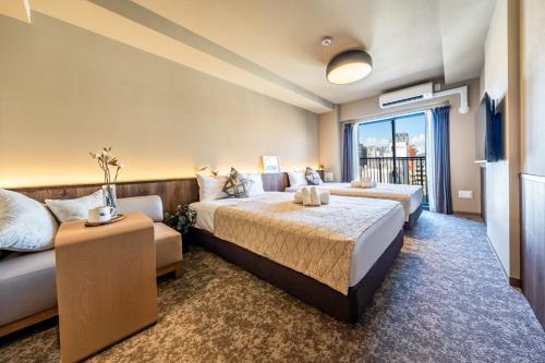 Postel nebo postele na pokoji v ubytování Apartment Hotel 11 Tsutenkaku