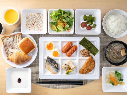 a bunch of plates of food on a table at Super Hotel Kochi in Kochi