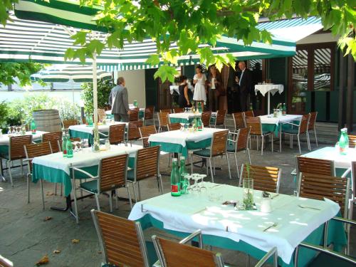 a group of tables and chairs with people standing around at Hotel Restaurant Rössle in Rankweil