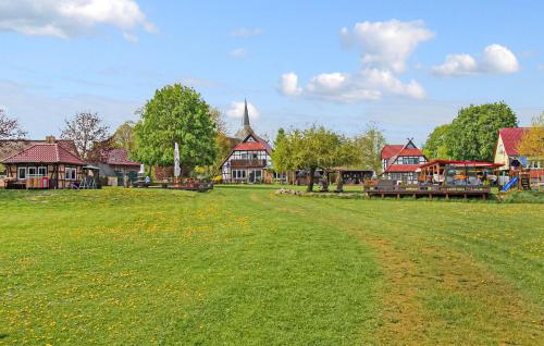 a large grass field with houses and a village at Ferienwohnung Südmüritz in Vipperow