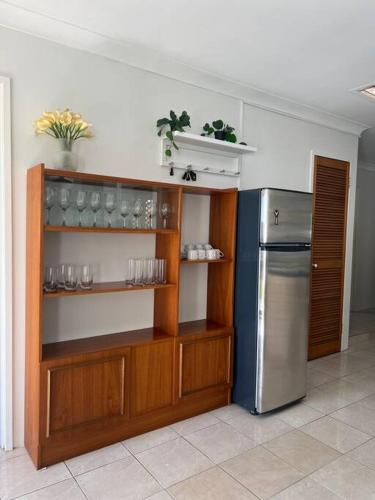 a kitchen with a stainless steel refrigerator and shelves at Family Home Away From Home in Rockingham
