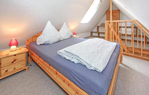 a bedroom with a bed with pillows and a staircase at Ferienwohnung Südmüritz in Vipperow