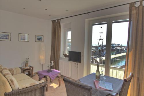 a living room with a table and a living room with a view at Ferienwohnung Kutterfisch direkt im Stadthafen in Sassnitz