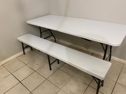 a white table and bench in a room at Haystack Hostel in Houston