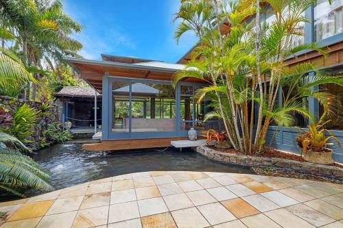 a house with a pool in the middle of a yard at Fuller Holidays -Ocean House - Beachfront Suffolk Park in Suffolk Park